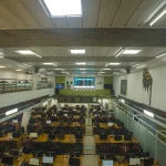 Busy stock exchange trading floor with rows of screens