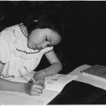 A person concentrating on work at a tidy desk