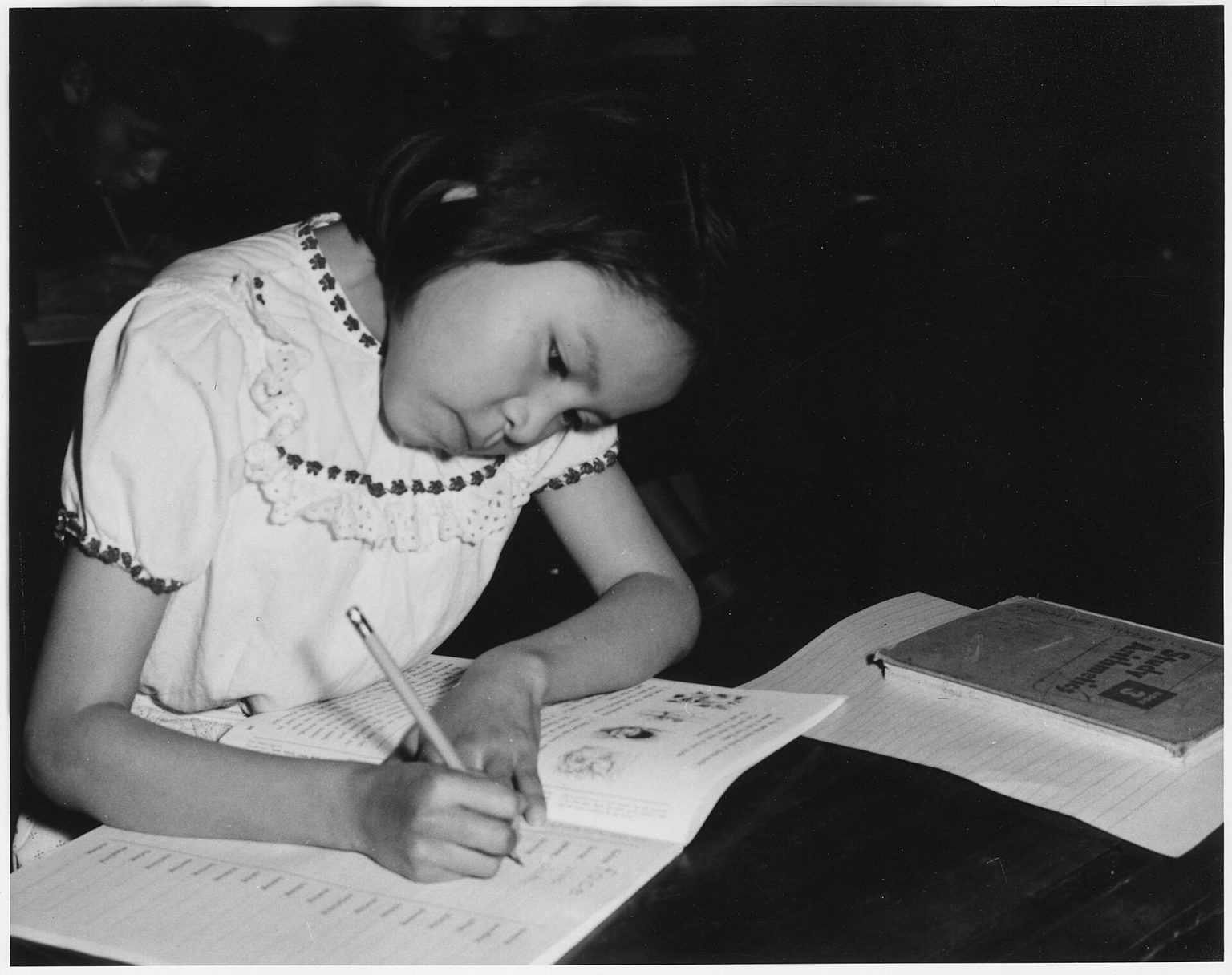 A person concentrating on work at a tidy desk