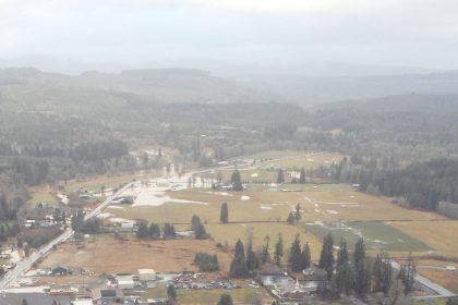 Aerial view of a flooded town with homes surrounded by water