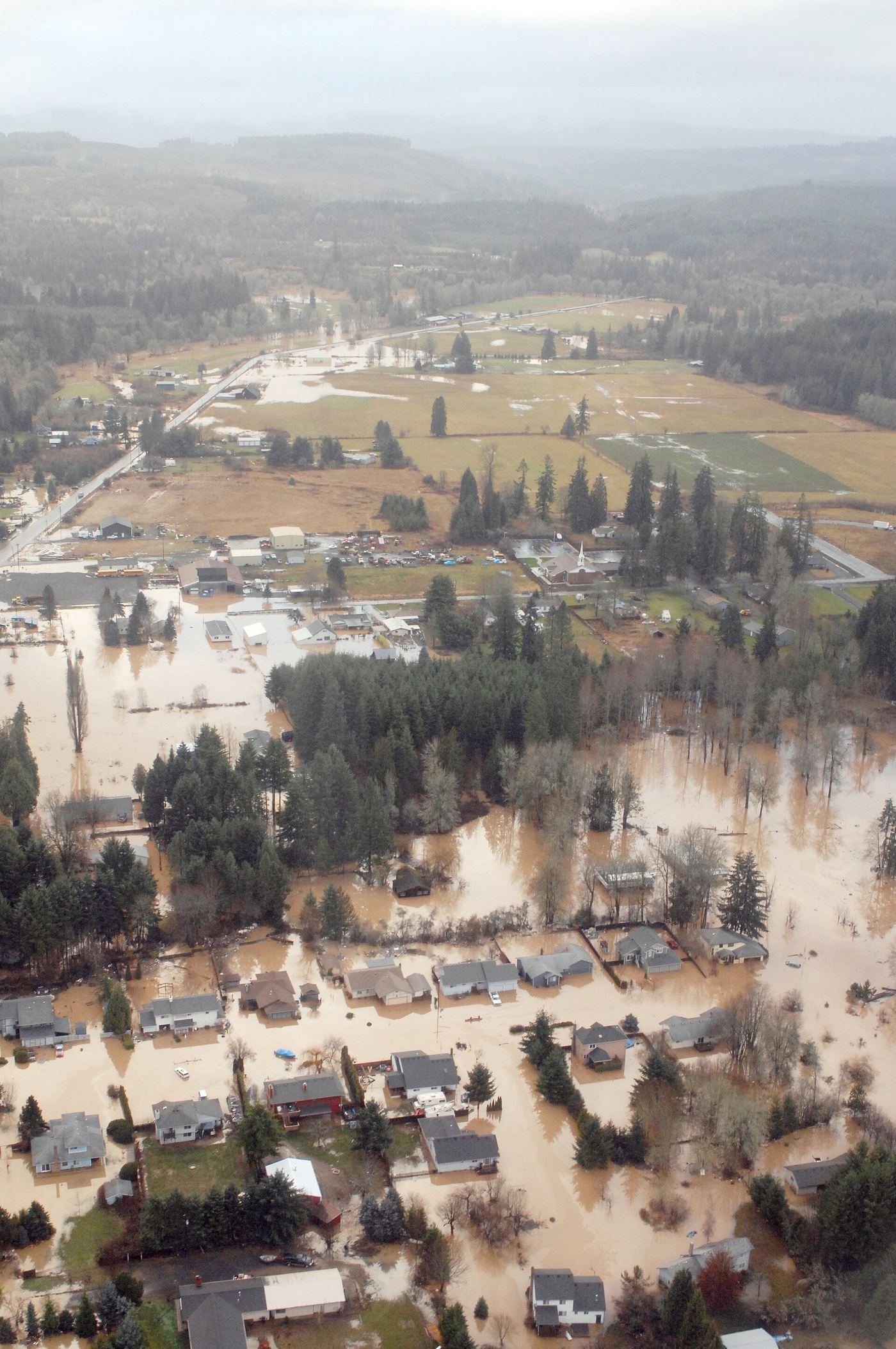 Aerial view of a flooded town with homes surrounded by water
