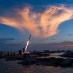SpaceX rocket launch creating a glowing jellyfish cloud in the twilight sky over the US east coast
