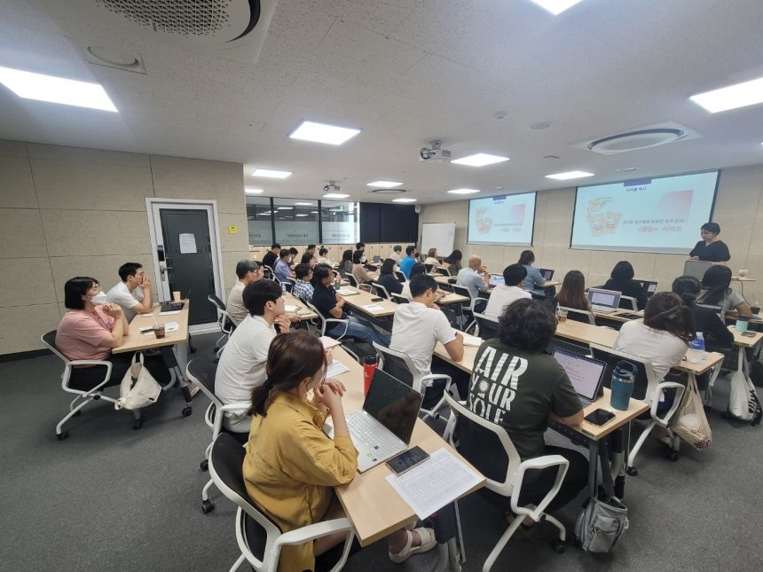 Students learning in a phone-free classroom with smartphones put away, illustrating a study on classroom bans and academic performance